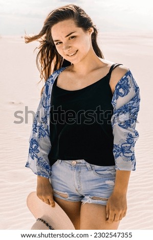 Similar – Young woman sits at the Baltic Sea beach