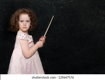 Girl at blackboard with a pointer