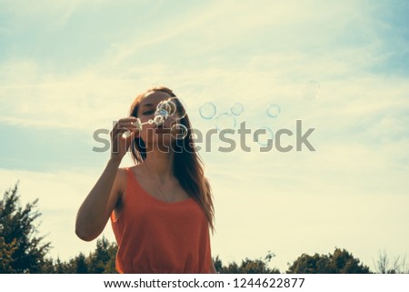 Similar – Young teenage girl blowing pink bubble gum