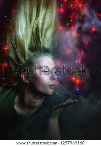 Girl blowing on palm