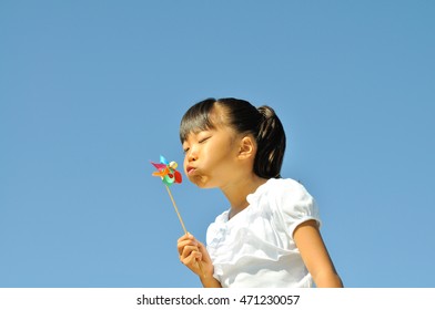 Girl Blowing Pinwheel