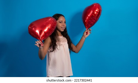 Girl With Blue Background, Holding Heart Balloons 