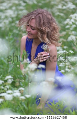 girl in a blue dress in a field