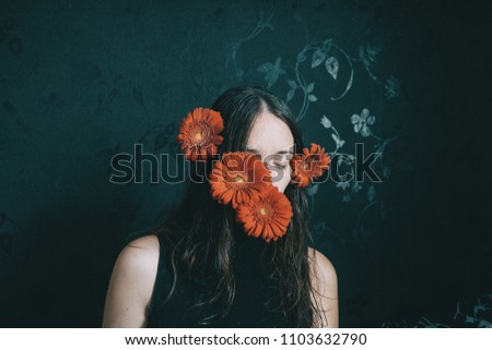 Similar – Foto Bild ein Mädchen mit blauen Augen und langem Haar, das sich mit einer Gerbera-Blüte bedeckt