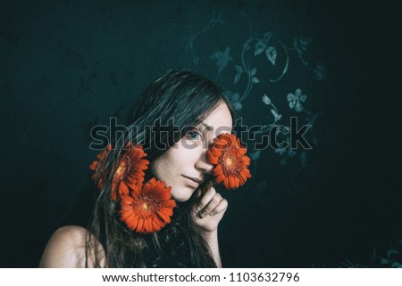 Similar – Foto Bild ein Mädchen mit blauen Augen und langem Haar, das sich mit einer Gerbera-Blüte bedeckt