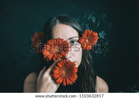 Similar – a girl with blue eyes and long hair with a beard of gerbera flowers