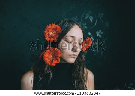 Similar – Foto Bild ein Mädchen mit blauen Augen und langem Haar, das sich mit einer Gerbera-Blüte bedeckt