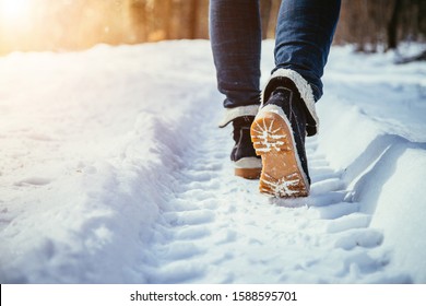 Girl In Blue Jeans Is Hiking In The Wintertime, Legs And Shoes