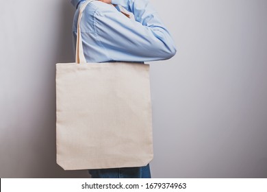 Girl In Blue Shirt Holds Blank Cotton Eco Tote Bag, Design Mockup.