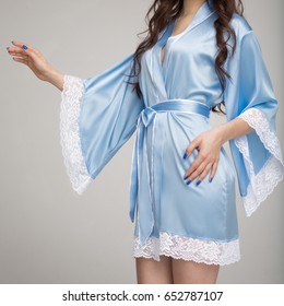 Girl In Blue Silk Robe, On Gray Background