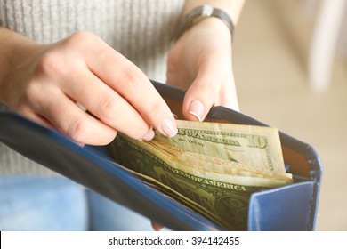 Girl with blue wallet full of money