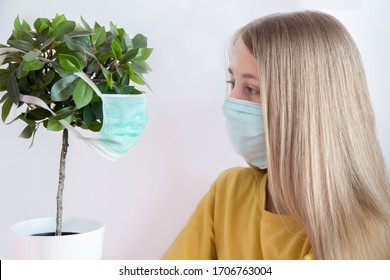 The girl and the Bonsai tree wear Medical Face Masks during the coronavirus covid-19 pandemic. Ecology and health care concept. - Powered by Shutterstock