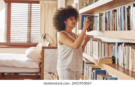 Girl, bookshelf and choice for reading in home, bedroom and morning to relax with thinking on vacation. Woman, person and happy with books, search or decision for story, novel or poetry in apartment