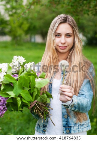 Girl with a bouquet of lilac flowers