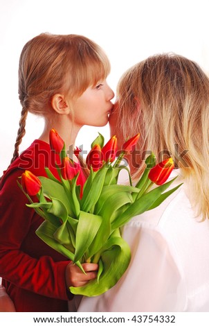 girl with bouquet of red-yellow tulips kissing mummy