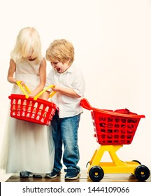 Girl And Boy Children Shopping. Kids Store. Couple Kids Hold Plastic Shopping Basket Toy. Buy With Discount. Family Shopping. Buy Products. Play Shop. Cute Buyer Customer Client Hold Shopping Cart.