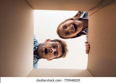 The Girl And The Boy Are Looking At The Empty Box. View From Inside The Box Close-up.