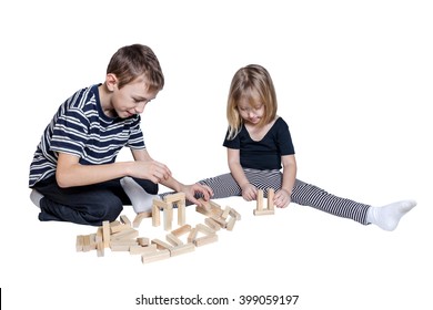 Girl And Boy Playing Blocks Jenga Isolated On White Background