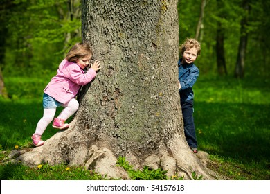 girl and boy playing hide and seek