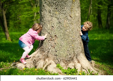 girl and boy playing hide and seek