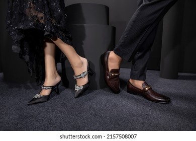 The girl and boy are standing on both, both have applied with your foot black stool, and has been placed on a foot below ground, girl wearing the Black net frock black high heel,boy black pent shirt.