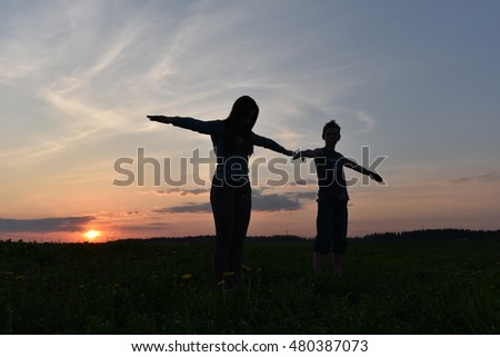 Similar – 2 junge Frauen sitzen auf der Wiese und sehen in die Ferne