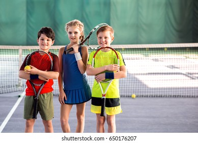 Girl and boys playing tennis with enjoyment