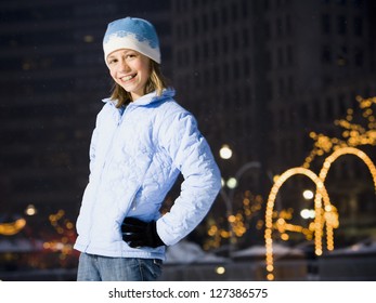 Girl With Braces Smiling Outdoors In Winter With Hands On Hips