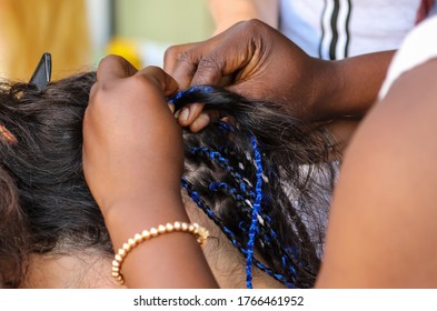 Girl Braids Blue African Braids In A Beauty Salon.