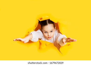 Girl Breaking Through Paper Wall. Unticipated Release