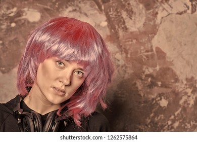 Girl With Bright Artificial Hair In Headset. Beauty And Fashion. Hairdresser Salon And Barbershop. Music Dj And Party. Woman In Pink Wig With Music Headphones, Copy Space