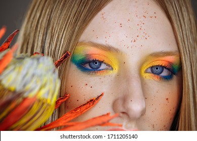 Girl with bright makeup and one flower.