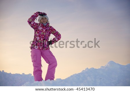 The girl in brightly pink suit against the blue sky
