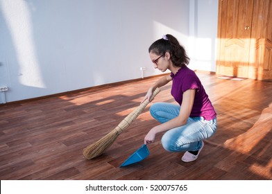 Girl With A Broom Making Cleaning An Empty Apartment