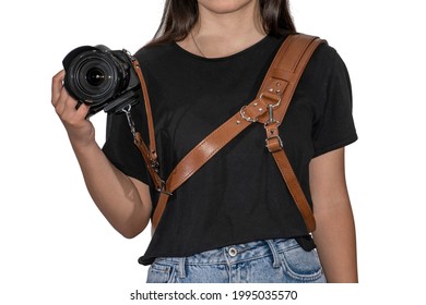 Girl with brown hand made natural leather camera shoulder strap isolated on a white background. Photographer equipment, stylish, vintage, retro feel. Clipping path