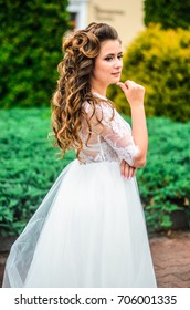 girl brunetka . Dressed in an elegant wedding dress , ball . beautiful hair and makeup - Shutterstock ID 706001335