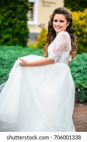 girl brunetka . Dressed in an elegant wedding dress , ball . beautiful hair and makeup - Shutterstock ID 706001338