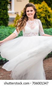 girl brunetka . Dressed in an elegant wedding dress , ball . beautiful hair and makeup - Shutterstock ID 706001347