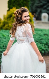 girl brunetka . Dressed in an elegant wedding dress , ball . beautiful hair and makeup - Shutterstock ID 706003561