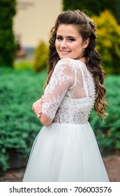 girl brunetka . Dressed in an elegant wedding dress , ball . beautiful hair and makeup - Shutterstock ID 706003576