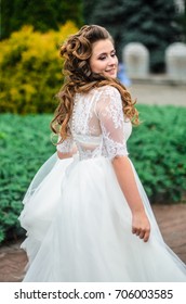 girl brunetka . Dressed in an elegant wedding dress , ball . beautiful hair and makeup - Shutterstock ID 706003585