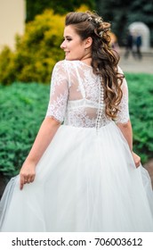 girl brunetka . Dressed in an elegant wedding dress , ball . beautiful hair and makeup - Shutterstock ID 706003612