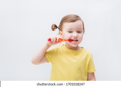 The Girl Brushes Her Teeth With A Toothbrush. Tooth Decay. It's A Problem With Teeth. Toothache.On White Background With Copy Space