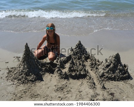 Girl building a sand castle on the beach