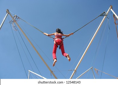 Girl Bungee Jumping On A Trampoline