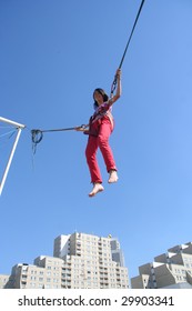 Girl Bungee Jumping On A Trampoline