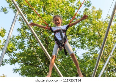 Girl Bungee Jumping In Trampoline