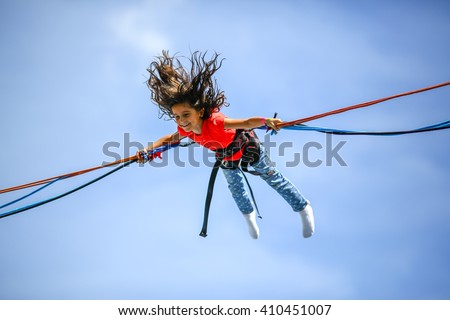 Similar – Image, Stock Photo Bungee jumping at trampoline. Little girl bouncing on bungee jumping in amusement park on summer vacations