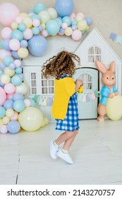 Girl In Bunny Ears Dye Colorful Egg For Easter Hunt. Home Decoration With Flowers, Basket And Rabbit For Spring Holiday Celebration.