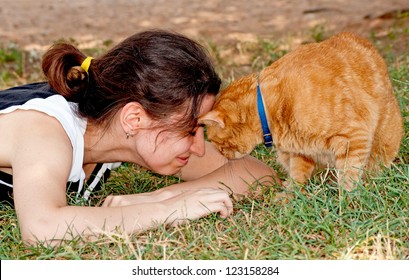 Girl Butting Heads With Her Ginger Cat